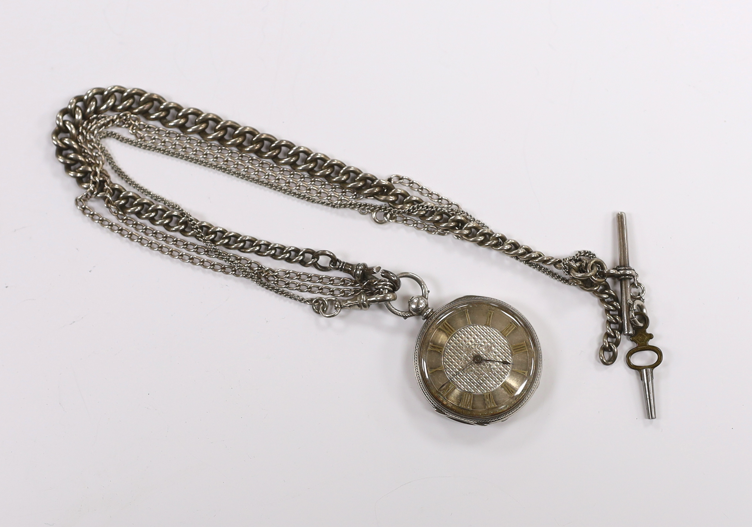 A white metal open face key wind fob watch on a silver albert.